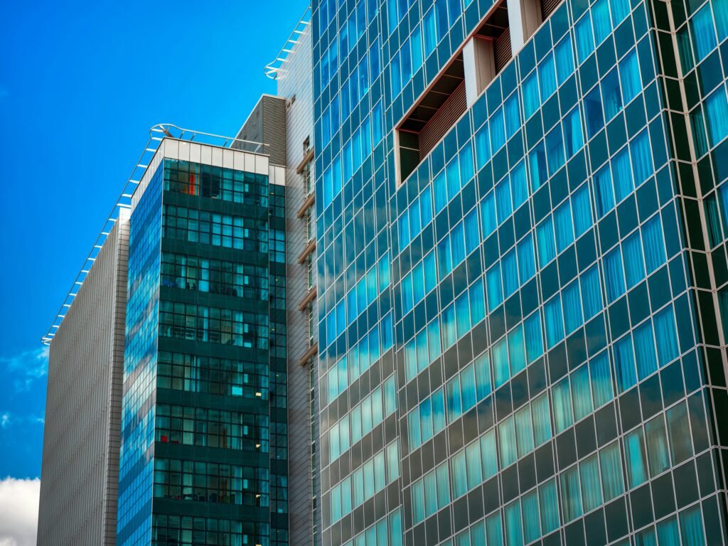 Stunning view of a contemporary skyscraper with a reflective glass facade against a blue sky.